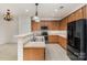 Well-equipped kitchen features plenty of cabinet space and tile flooring with a breakfast bar at 7031 Woodbridge Valley Cir, Charlotte, NC 28227