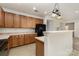 Kitchen area with wood cabinets, stainless appliances, breakfast bar, and easy access to other living spaces at 7031 Woodbridge Valley Cir, Charlotte, NC 28227