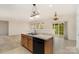 Open kitchen features a breakfast bar overlooking the living area and sliding glass doors to the patio at 7031 Woodbridge Valley Cir, Charlotte, NC 28227