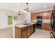 Bright kitchen with stainless steel appliances, wood cabinets, and access to the outdoor patio at 7031 Woodbridge Valley Cir, Charlotte, NC 28227