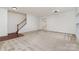 Neutral colored living room with bright natural light and staircase at 7031 Woodbridge Valley Cir, Charlotte, NC 28227