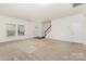 Neutral colored living room with bright natural light and staircase at 7031 Woodbridge Valley Cir, Charlotte, NC 28227