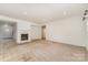 Spacious living room features a fireplace and neutral carpeting, perfect for relaxation and entertaining at 7031 Woodbridge Valley Cir, Charlotte, NC 28227