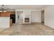 Neutral-colored living room boasts a fireplace and view into kitchen at 7031 Woodbridge Valley Cir, Charlotte, NC 28227