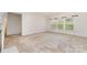 Bright living room with plush carpeting, ample natural light, and neutral tones, ideal for customization at 7031 Woodbridge Valley Cir, Charlotte, NC 28227
