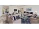 Bright living room is virtually staged with neutral colors and a calming blue accent decor at 7031 Woodbridge Valley Cir, Charlotte, NC 28227