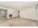 Large, open living room features a fireplace and neutral carpet at 7031 Woodbridge Valley Cir, Charlotte, NC 28227