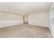 Spacious living room with neutral tones, bright recessed lighting, and large window letting in natural light at 7031 Woodbridge Valley Cir, Charlotte, NC 28227