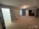 Basement features carpet flooring, closet, and access to other rooms at 715 Larimer Ln, Charlotte, NC 28262