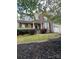 Charming home exterior with a welcoming front porch, manicured landscaping, and brick accents at 715 Larimer Ln, Charlotte, NC 28262