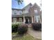 Charming home exterior with a welcoming front porch, manicured landscaping, and brick accents at 715 Larimer Ln, Charlotte, NC 28262