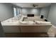 A neutral living room featuring a large couch, ceiling fan, and carpeted floors at 715 Larimer Ln, Charlotte, NC 28262