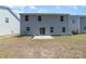 View of the exterior home and yard including the concrete patio and privacy fence at 725 Pointe Andrews Dr, Concord, NC 28025