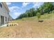 Wide open backyard with potential for lots of activities including grass, garden space and access to woods at 725 Pointe Andrews Dr, Concord, NC 28025