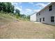 Expansive backyard space, perfect for outdoor activities and relaxation, next to a siding-lined house at 725 Pointe Andrews Dr, Concord, NC 28025