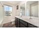 Bathroom featuring a double vanity, large mirror, framed artwork, and a window that brings in natural light at 725 Pointe Andrews Dr, Concord, NC 28025