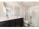 Bathroom featuring dual sink vanity, large mirror and a glass shower in a modern designed home at 725 Pointe Andrews Dr, Concord, NC 28025