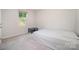 Neutral bedroom featuring a bed, side table, and window providing lots of natural light at 725 Pointe Andrews Dr, Concord, NC 28025