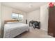Bright bedroom features a comfortable bed, a desk with a chair, and a window that lets in plenty of natural light at 725 Pointe Andrews Dr, Concord, NC 28025