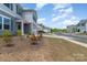 Street view of a charming two-story home featuring a manicured lawn and inviting entrance at 725 Pointe Andrews Dr, Concord, NC 28025