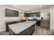 Stylish kitchen with stainless steel appliances, granite countertops, and gray cabinets at 725 Pointe Andrews Dr, Concord, NC 28025