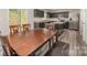 Eat-in kitchen featuring gray cabinets, stainless appliances, and dark wood dining table at 725 Pointe Andrews Dr, Concord, NC 28025
