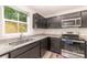 Beautiful kitchen with granite countertops, stainless steel appliances, and gray cabinets at 725 Pointe Andrews Dr, Concord, NC 28025