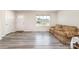 Bright living room featuring vinyl floors, a front door and a large window with neighborhood views at 725 Pointe Andrews Dr, Concord, NC 28025