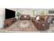 Comfortable living room with a sofa, a media center, and a patterned rug on vinyl floors at 725 Pointe Andrews Dr, Concord, NC 28025