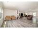 Spacious living room with two sofas and plenty of light, showcasing modern vinyl floors at 725 Pointe Andrews Dr, Concord, NC 28025