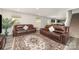 Open-concept living room featuring sofas, views to a kitchen, vinyl floors, and natural light at 725 Pointe Andrews Dr, Concord, NC 28025
