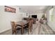 Open floor plan showing the dark wood dining table and leather couches at 725 Pointe Andrews Dr, Concord, NC 28025