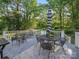 Relaxing backyard featuring a large deck area and an umbrella shaded dining set at 8017 Nathanael Greene Ln, Charlotte, NC 28227