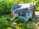 Aerial view of the home's backyard with a white deck with an outdoor dining set amongst mature trees at 8017 Nathanael Greene Ln, Charlotte, NC 28227
