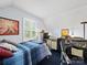 Cozy bedroom setup with a treadmill, workspace, and plenty of natural light at 8017 Nathanael Greene Ln, Charlotte, NC 28227