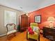 Stylish bedroom boasts rich hardwood floors and a colorful accent wall at 8017 Nathanael Greene Ln, Charlotte, NC 28227