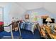 Bright bedroom including a treadmill, desk, and light blue colored walls at 8017 Nathanael Greene Ln, Charlotte, NC 28227
