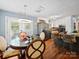 Bright dining area with a modern light fixture, a round glass-top table, and easy access to the stainless steel appliances at 8017 Nathanael Greene Ln, Charlotte, NC 28227