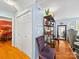 Hallway with hardwood floors, storage closet, and easy access to the bedroom, offering functional space and style at 8017 Nathanael Greene Ln, Charlotte, NC 28227