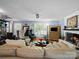 A well-lit living room showcases hardwood floors, plush furniture, a white painted fireplace, and decorative lighting at 8017 Nathanael Greene Ln, Charlotte, NC 28227