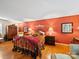 Elegantly decorated bedroom featuring warm-toned walls, hardwood floors, ornate furnishings, and accent lighting creating a cozy retreat at 8017 Nathanael Greene Ln, Charlotte, NC 28227