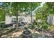 Backyard with a stone fire pit and an outdoor entertaining area at 8056 Stevens Mill Rd, Matthews, NC 28104