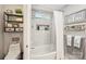 Upgraded bathroom showcasing a shower with a rain showerhead, built in shelves and decorative shelves at 8056 Stevens Mill Rd, Matthews, NC 28104