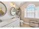 Bright bathroom featuring double vanity, decorative mirrors, a window, a toilet, and tasteful decor at 8056 Stevens Mill Rd, Matthews, NC 28104