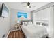 Cozy bedroom featuring hardwood floors, a ceiling fan, and a queen size bed with decorative blue pillows at 8056 Stevens Mill Rd, Matthews, NC 28104