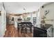 Open dining area with kitchen featuring modern stainless steel appliances, ample light, and seating for six at 8056 Stevens Mill Rd, Matthews, NC 28104