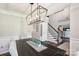 Elegant dining room with modern chandelier, staircase, and decorative accents creating a sophisticated ambiance at 8056 Stevens Mill Rd, Matthews, NC 28104