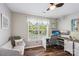 Bright home office with a dedicated workspace, comfortable sofa, and natural light at 8056 Stevens Mill Rd, Matthews, NC 28104