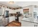 Well-lit kitchen with granite counters, stainless steel appliances, white cabinets, and hardwood floors at 8056 Stevens Mill Rd, Matthews, NC 28104