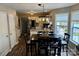 Open kitchen and dining area featuring modern lighting, stainless steel appliances, and hardwood floors at 8056 Stevens Mill Rd, Matthews, NC 28104